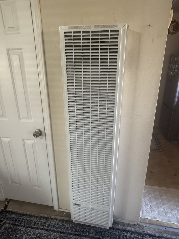 Newly-installed wall heater in a Bay Area apartment — the kind of working appliance Tech Aid for Refugees helps families receive