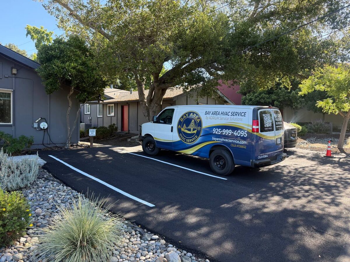 Bay Area HVAC Service van parked beside a gray multi-unit building