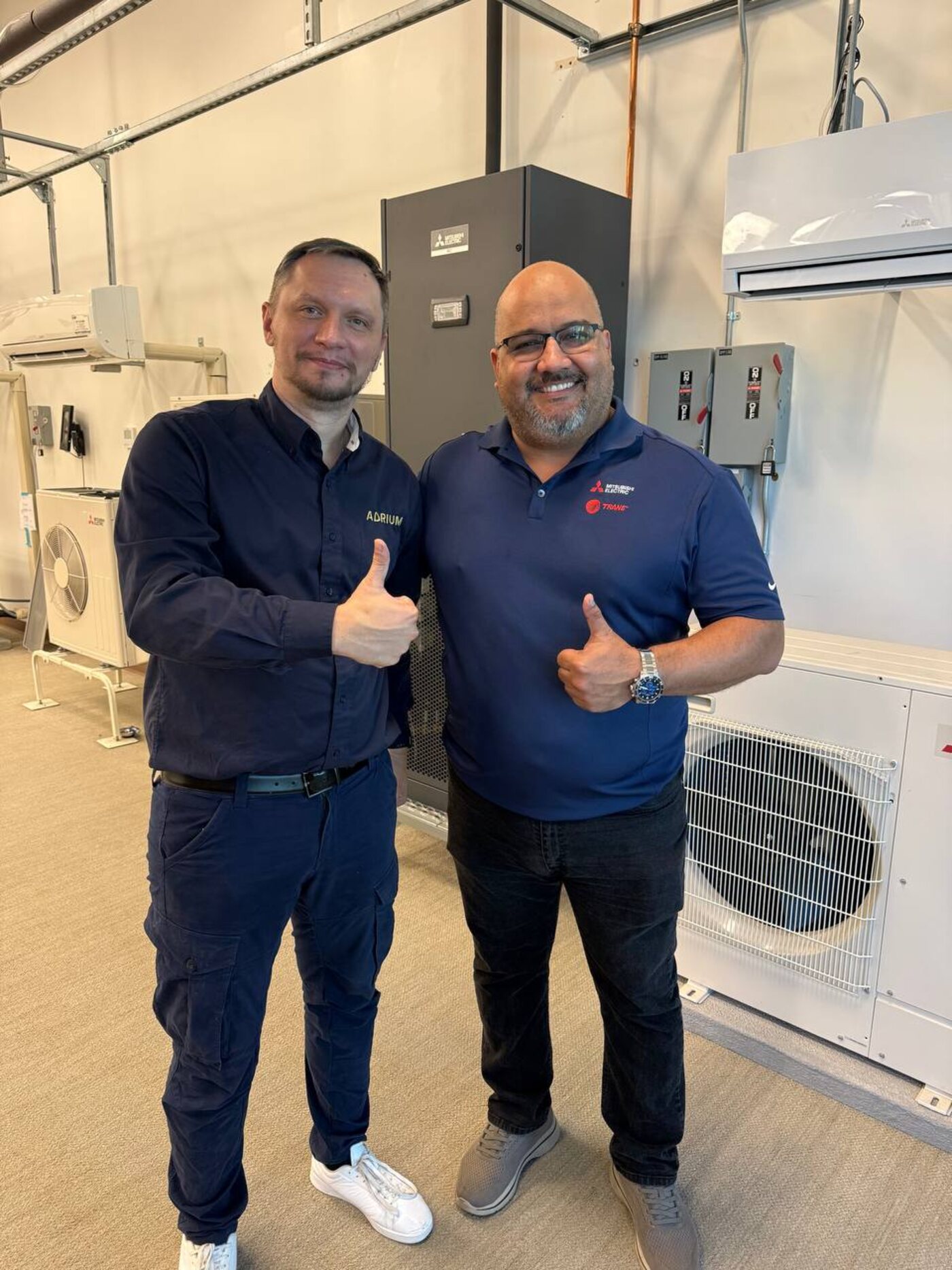 Andrew Kuznetsov with a Mitsubishi Electric instructor at the Los Angeles factory training center, June 2026