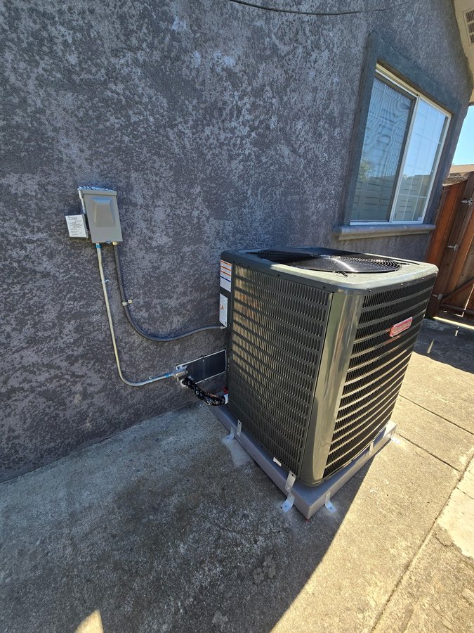 Installed Goodman 5-ton heat pump condenser unit on concrete pad, Union City
