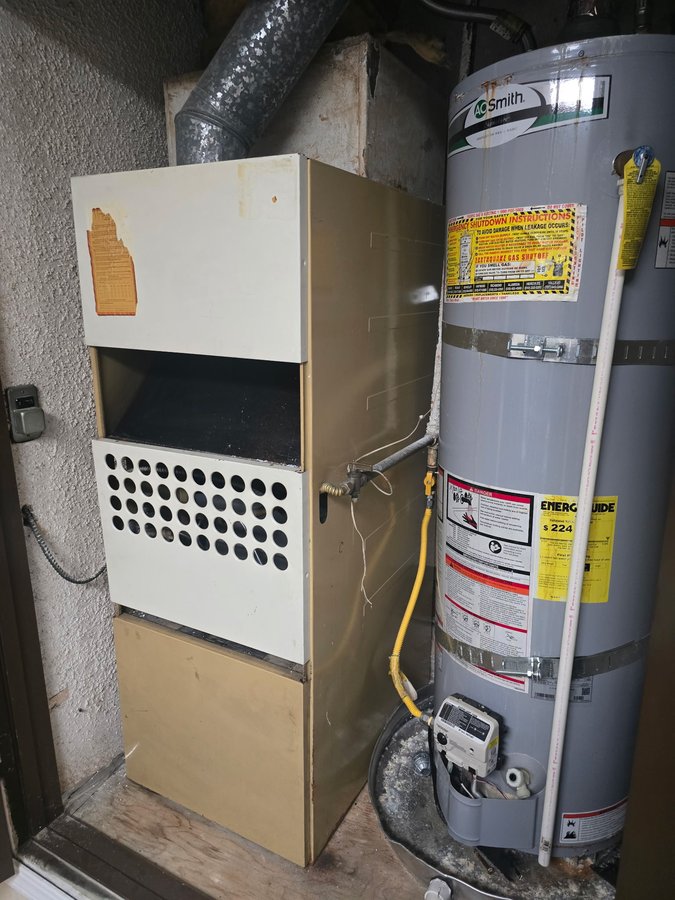 Aging gas furnace in place before removal for heat pump conversion in Union City