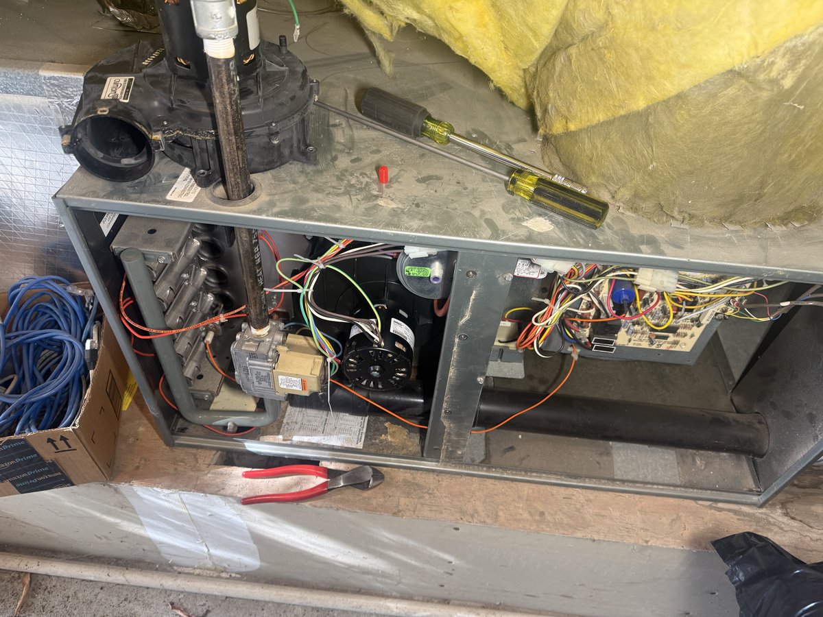 Ruud furnace access panel removed, internal components exposed for inducer replacement, Alamo