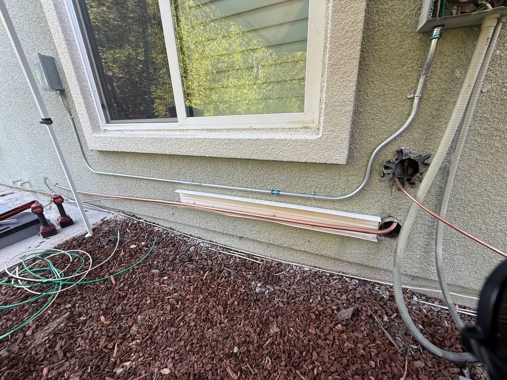 Carrier 19 SEER heat pump installation in progress — refrigerant line installation in San Ramon