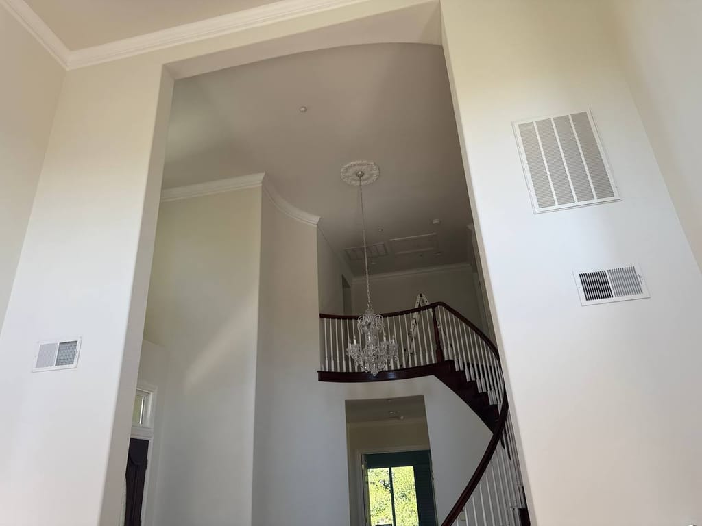 Interior foyer showing supply and return air grilles served by the new heat pump system, San Ramon