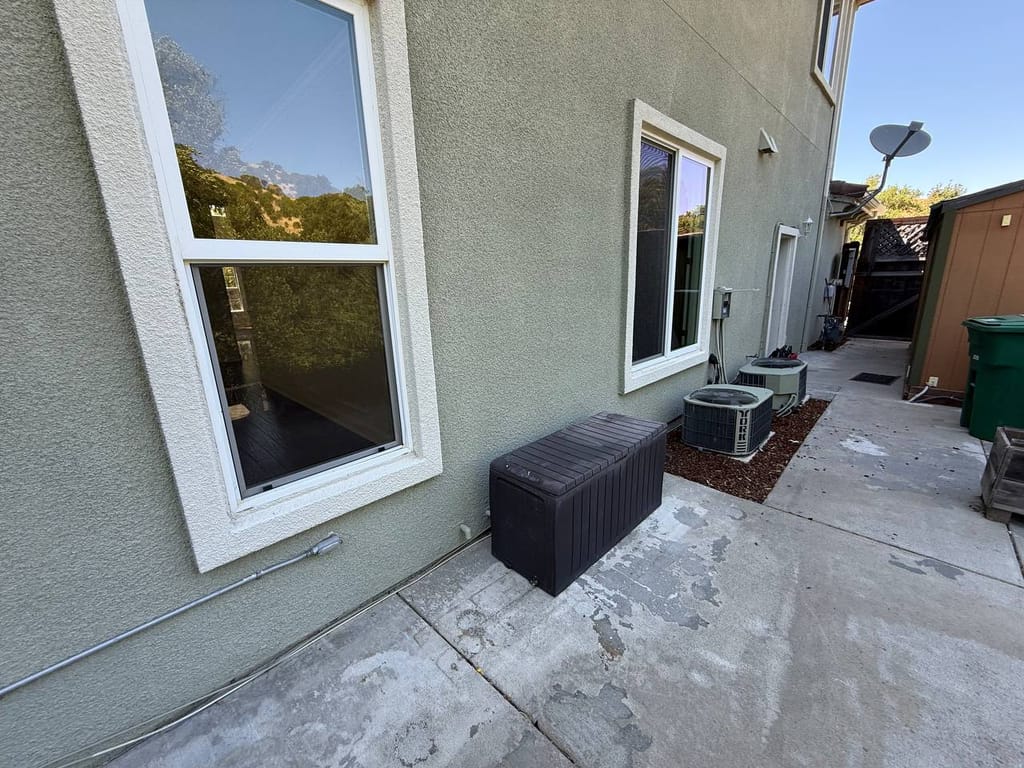 Existing AC condenser and side-yard work area before refrigerant line replacement, San Ramon
