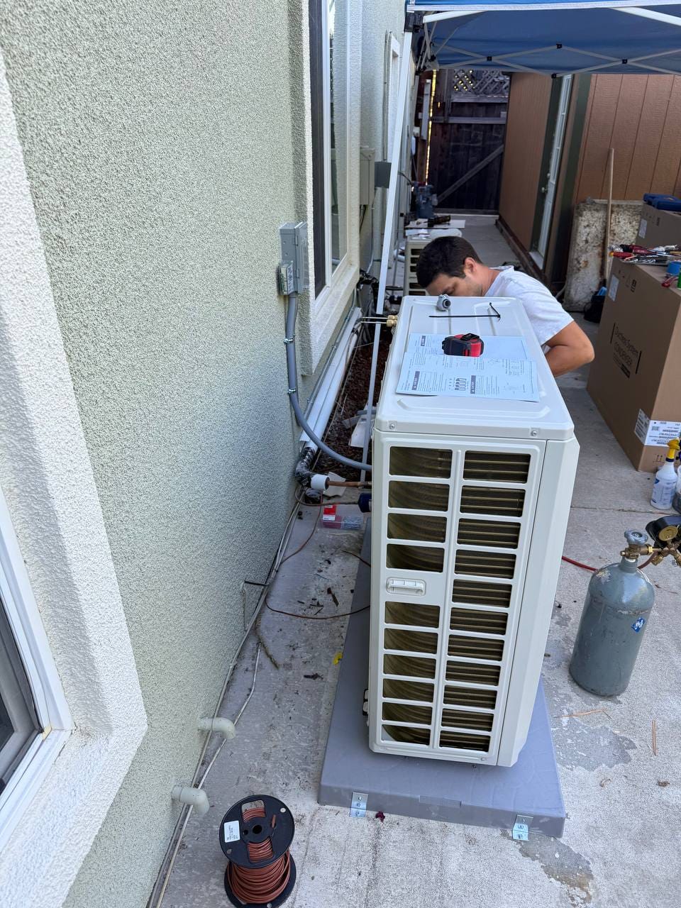 Carrier 19 SEER heat pump installation in progress — technician at work in San Ramon
