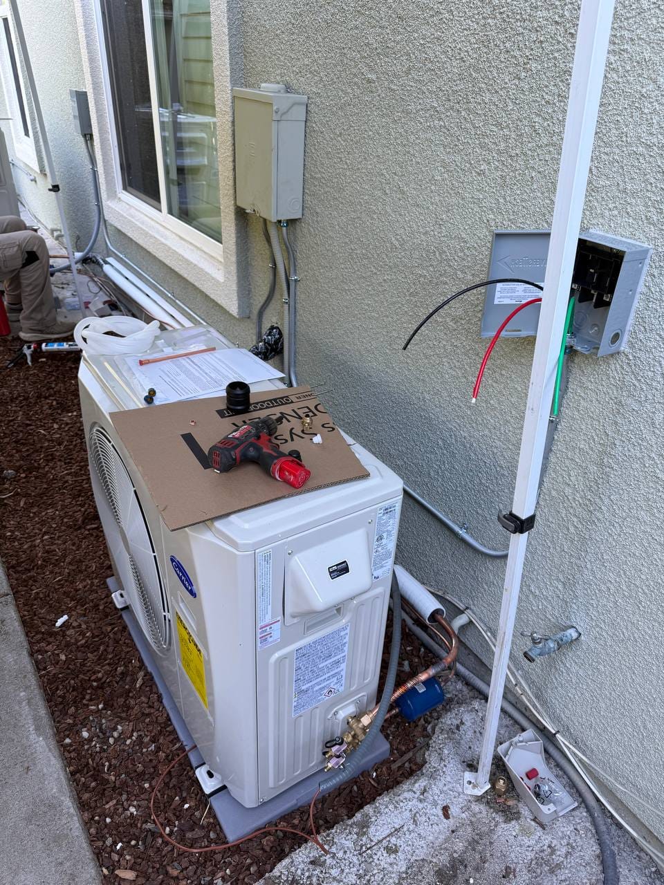 Carrier 19 SEER heat pump installation in progress — technician at work in San Ramon