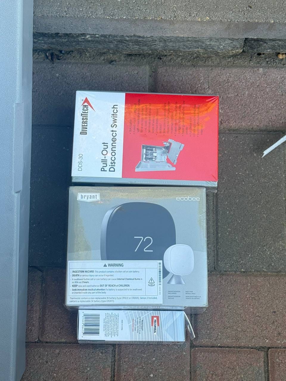 New disconnect switch and Bryant ecobee thermostat in packaging before install, Pleasanton