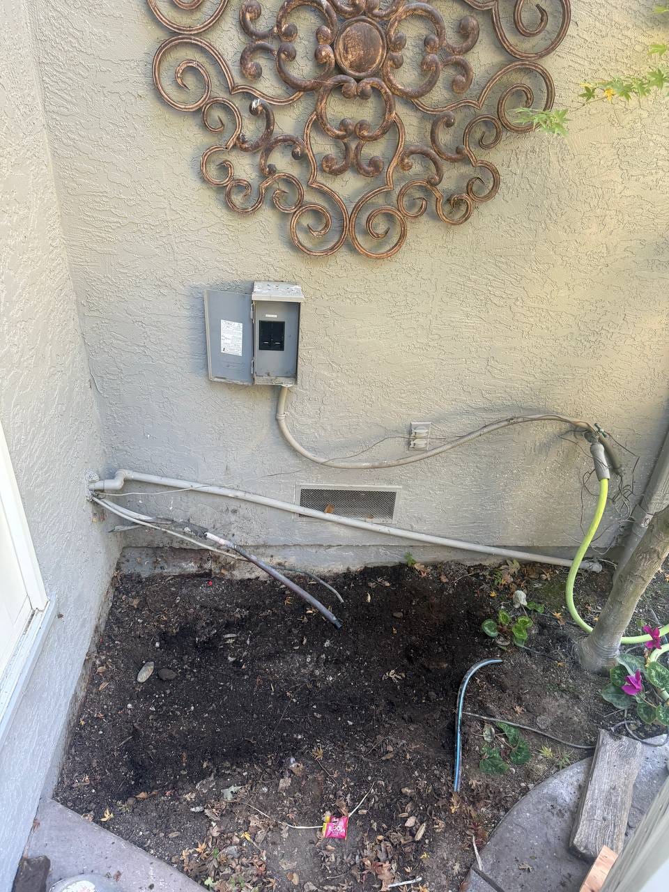 New electrical disconnect and conduit run at cleared condenser location during install, Pleasanton