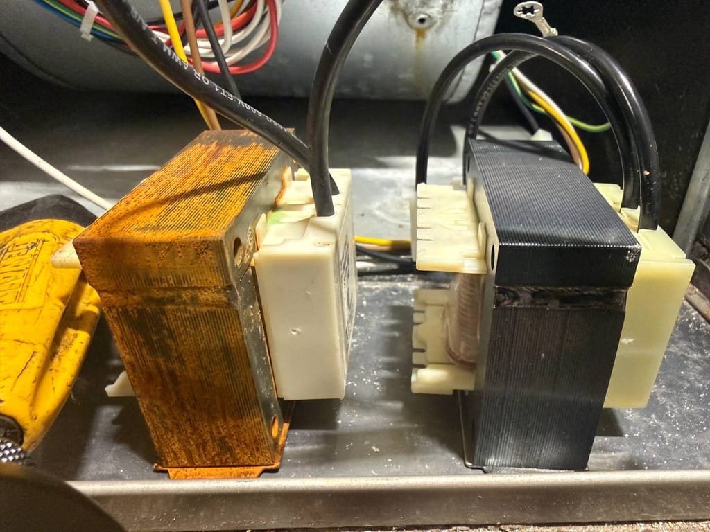 Rust-corroded old furnace transformer next to clean new replacement part, Pleasanton