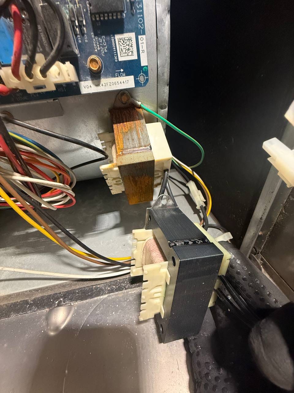 Corroded old transformer beside new replacement at Carrier furnace control board, Pleasanton