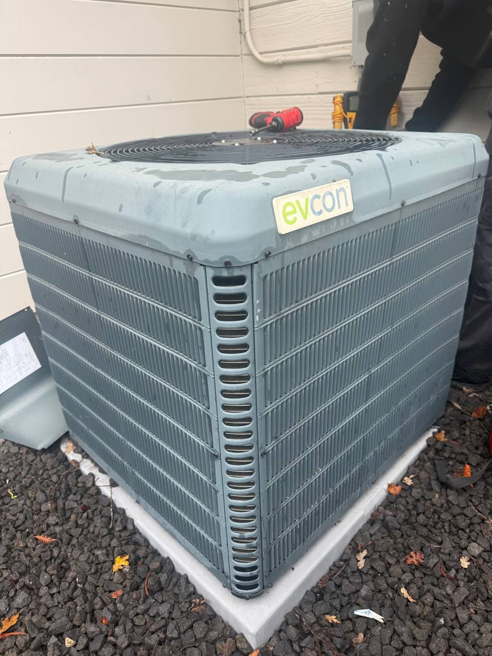Old EVCON outdoor AC condenser, worn and dirty, before removal for heat pump replacement, Walnut Creek