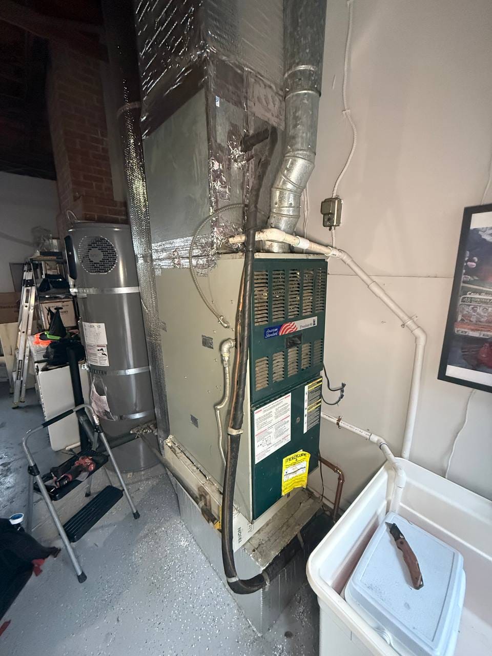 Old American Standard gas furnace in the garage before removal for heat pump conversion, Walnut Creek