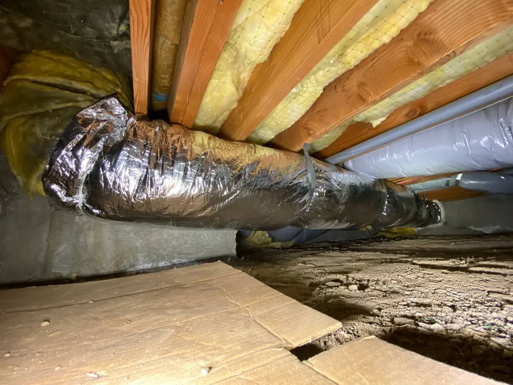Damaged old flex duct with torn foil jacket sagging in crawl space before repair, Walnut Creek