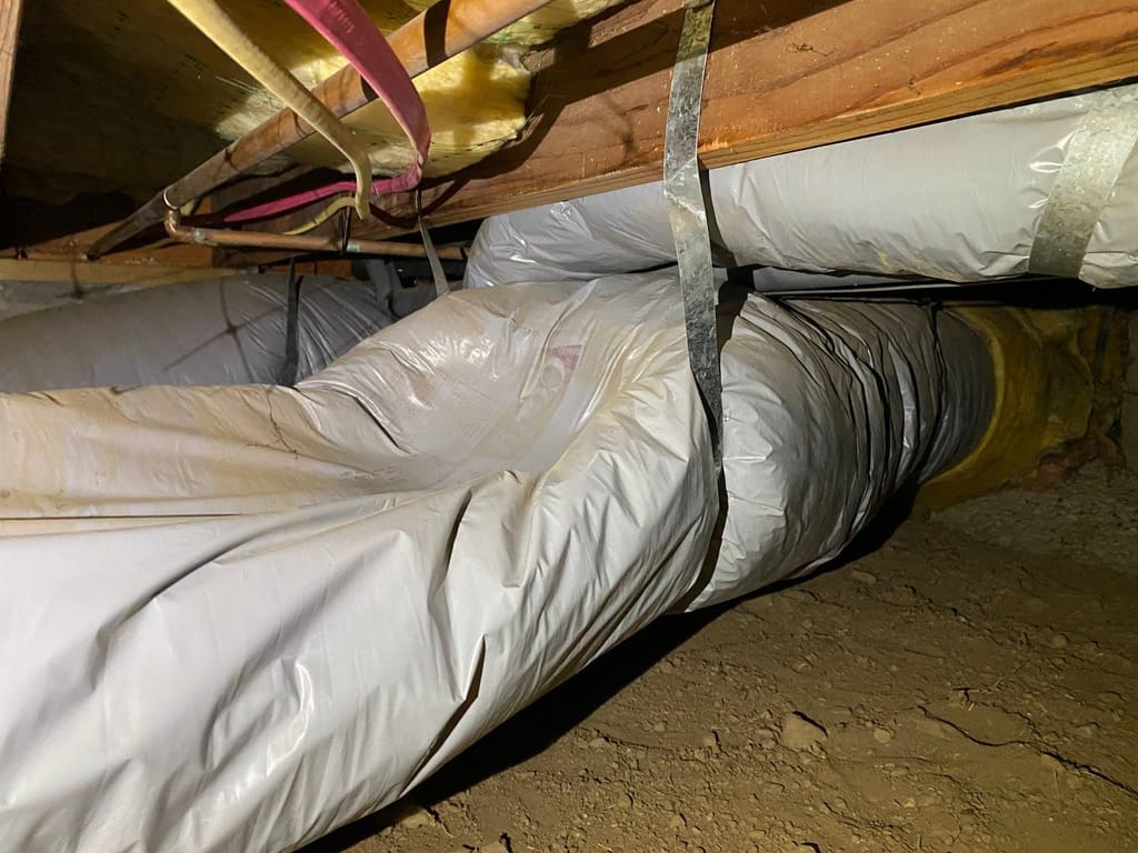 Torn, sagging flex ductwork on strap hangers in the crawl space before repair, Walnut Creek