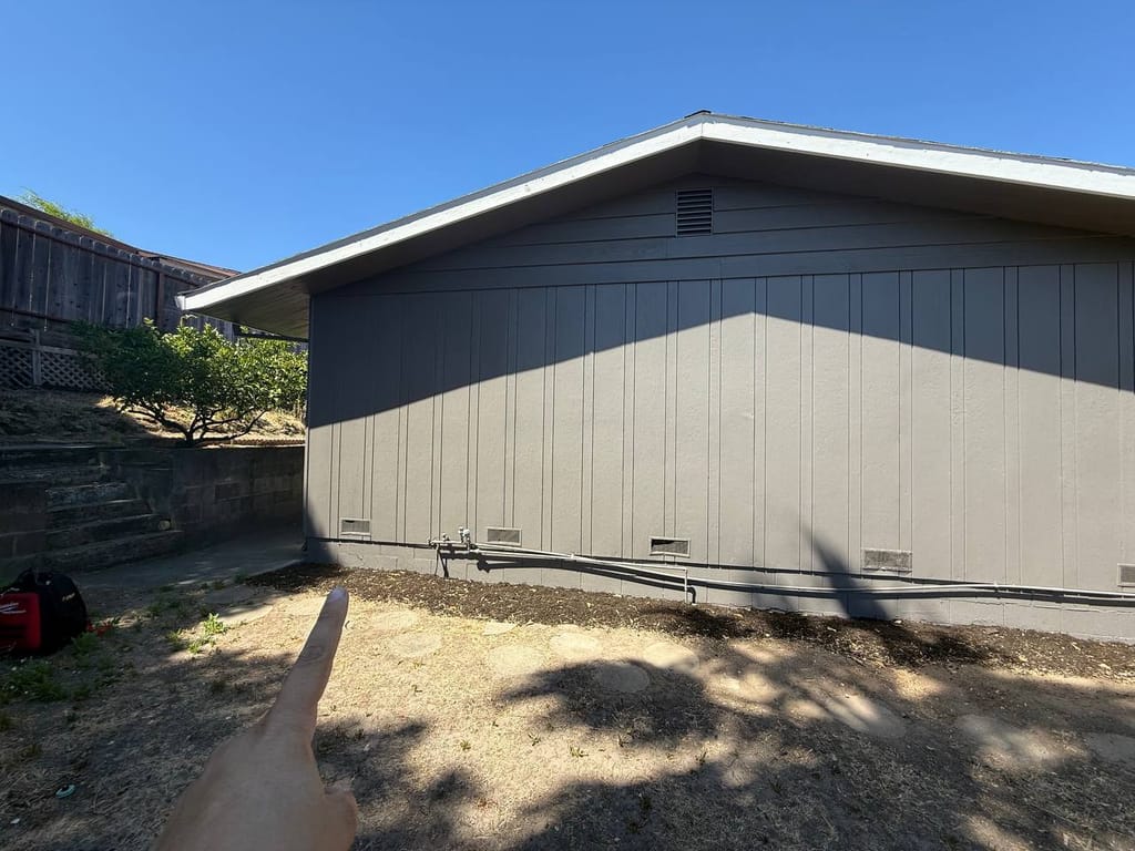 Exterior wall and yard where the new condenser will be sited, before placement, Martinez