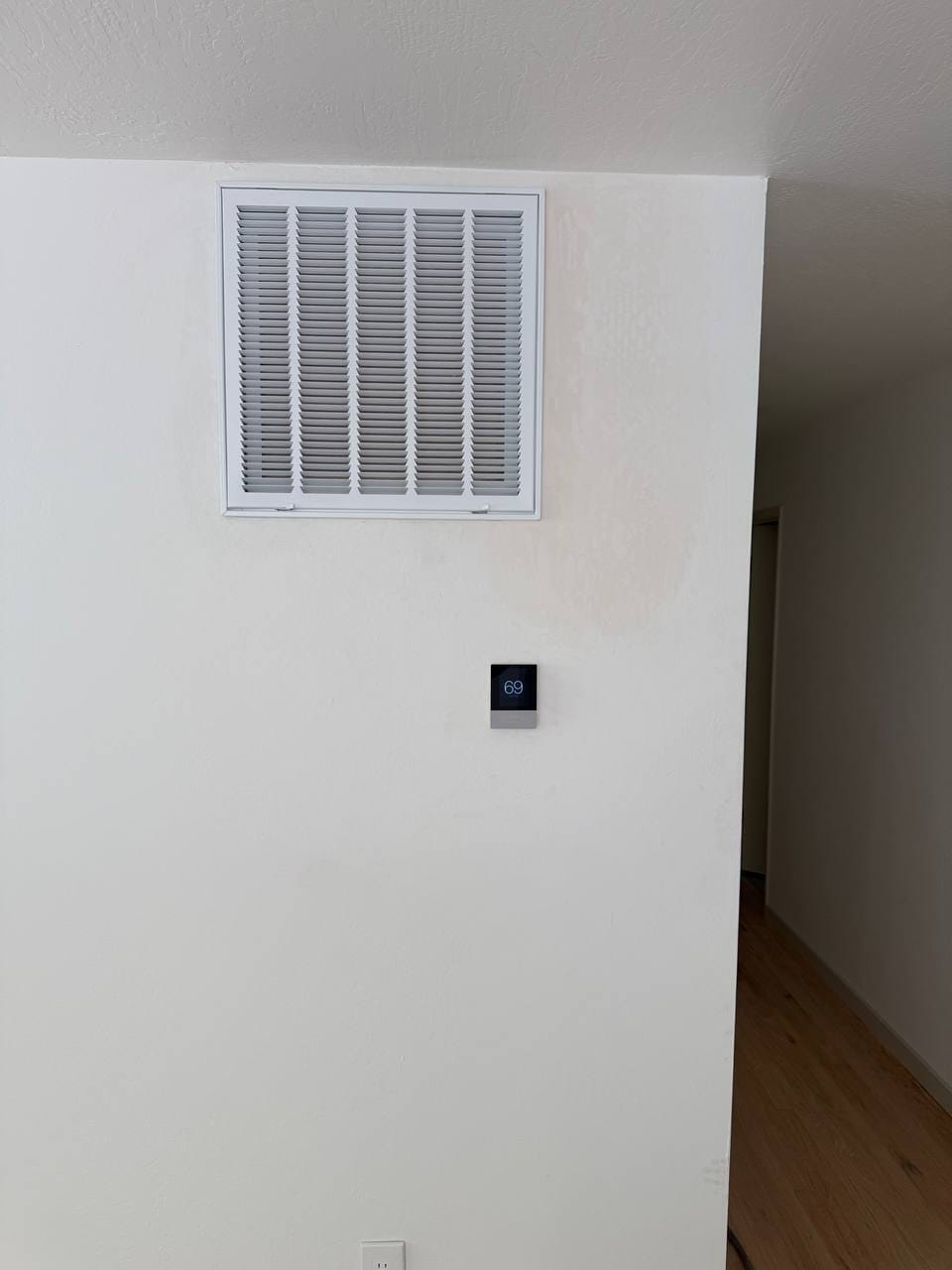 New smart thermostat and return-air grille after heat pump installation, Martinez