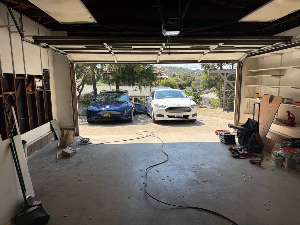 Garage cleared and tools staged during heat pump installation, Martinez