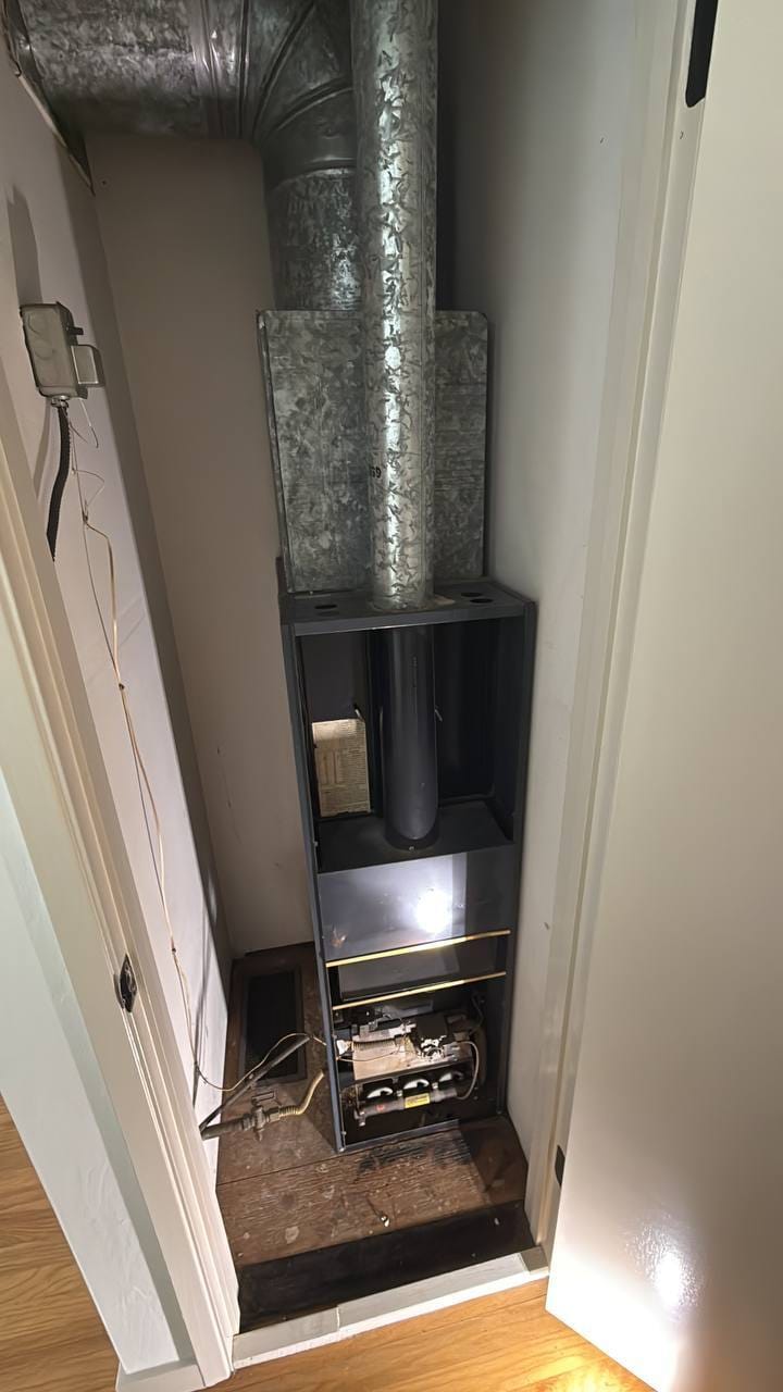 Old gas furnace open in closet with galvanized ducting before removal, Martinez