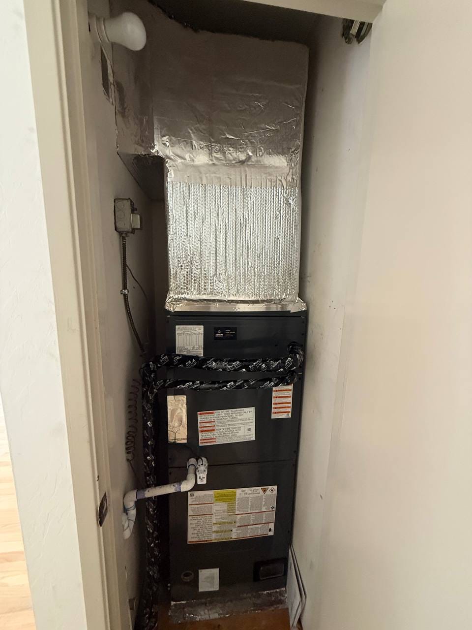 New Goodman air handler with insulated refrigerant linesets connected during installation, Martinez