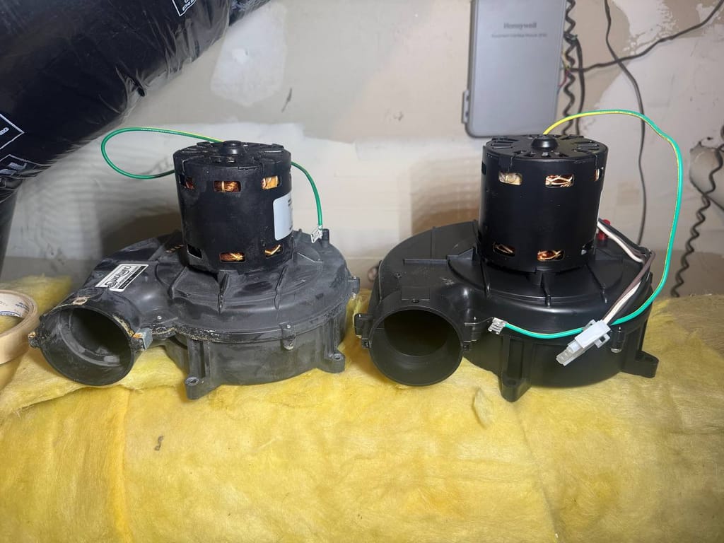 Old inducer/blower motor assembly (left) next to new replacement unit (right) during Ruud furnace repair, Alamo