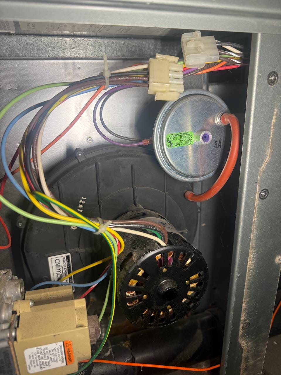 Inducer motor, pressure switch and wiring inside the Ruud furnace during repair, Alamo