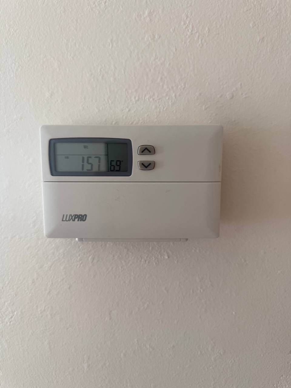 Old LuxPro programmable thermostat with scrambled program display before replacement, Walnut Creek