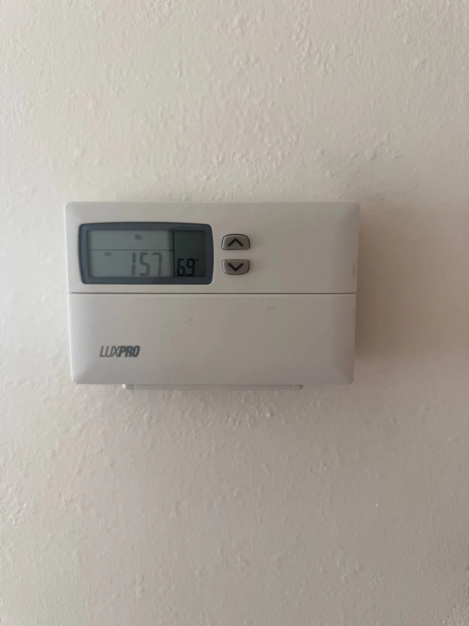 Old LuxPro programmable thermostat with scrambled program display before replacement, Walnut Creek