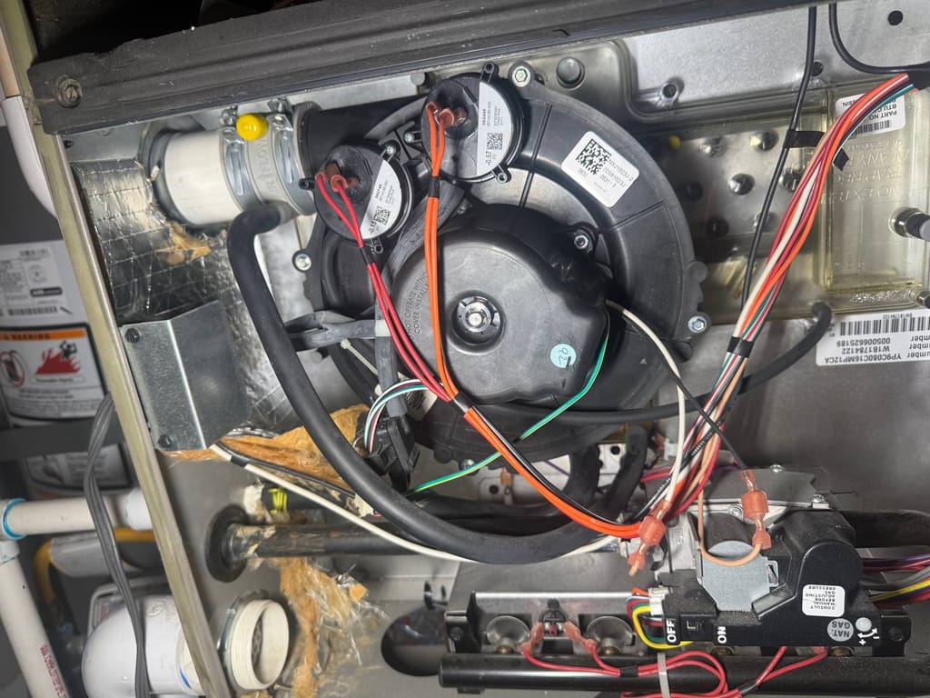 York furnace interior with inducer motor, gas valve and control board during repair, Dublin