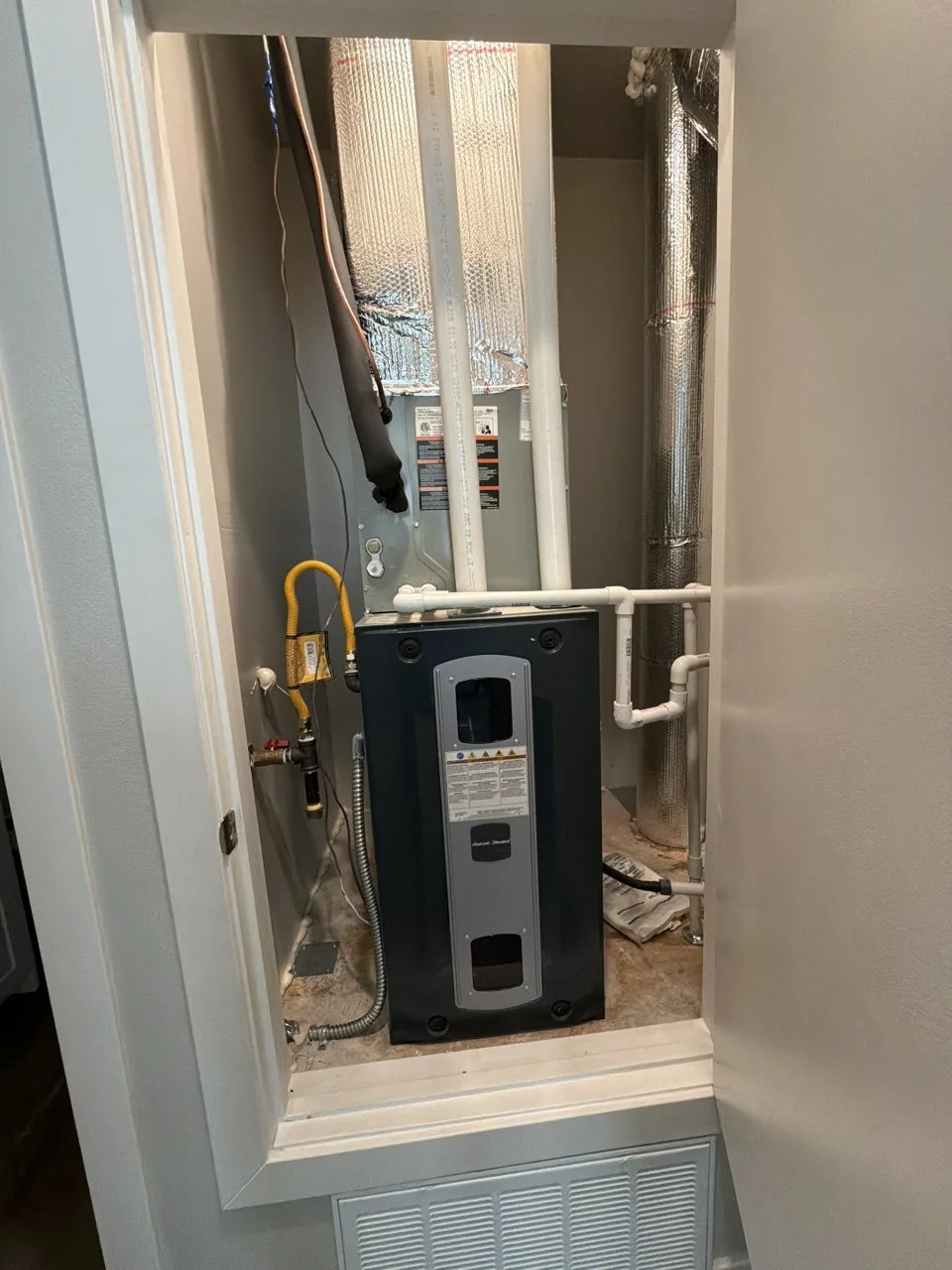 American Standard gas furnace and cooling coil in a hallway closet in Fremont, before the AC repair