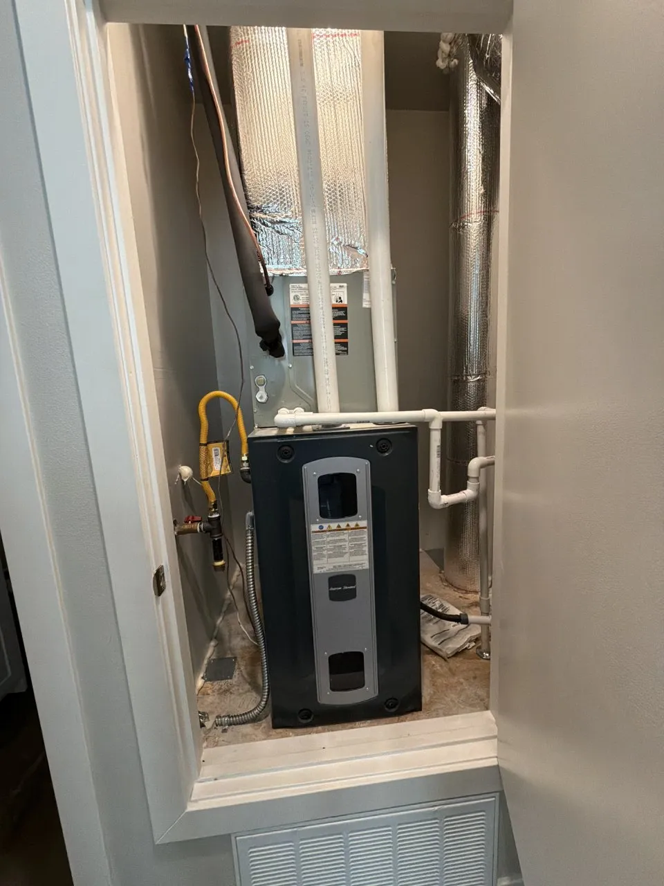 American Standard gas furnace and cooling coil in a hallway closet in Fremont, before the AC repair