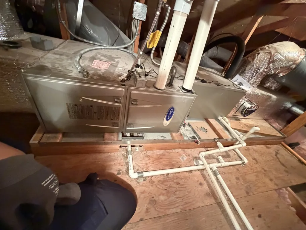 Carrier furnace in a San Mateo attic with the primary and emergency condensate drain lines