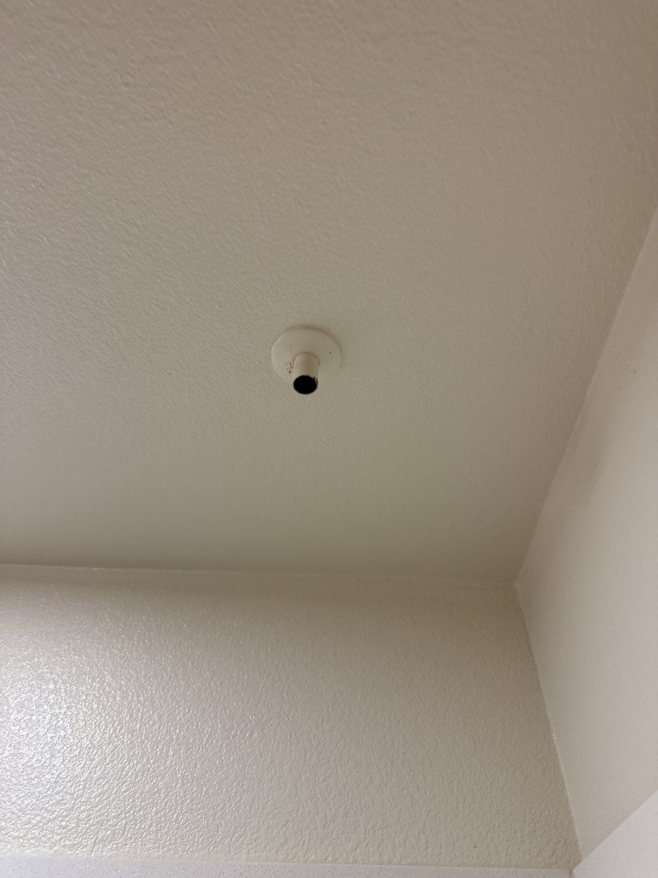 Emergency condensate drain outlet in the bathroom ceiling above the tub, San Jose