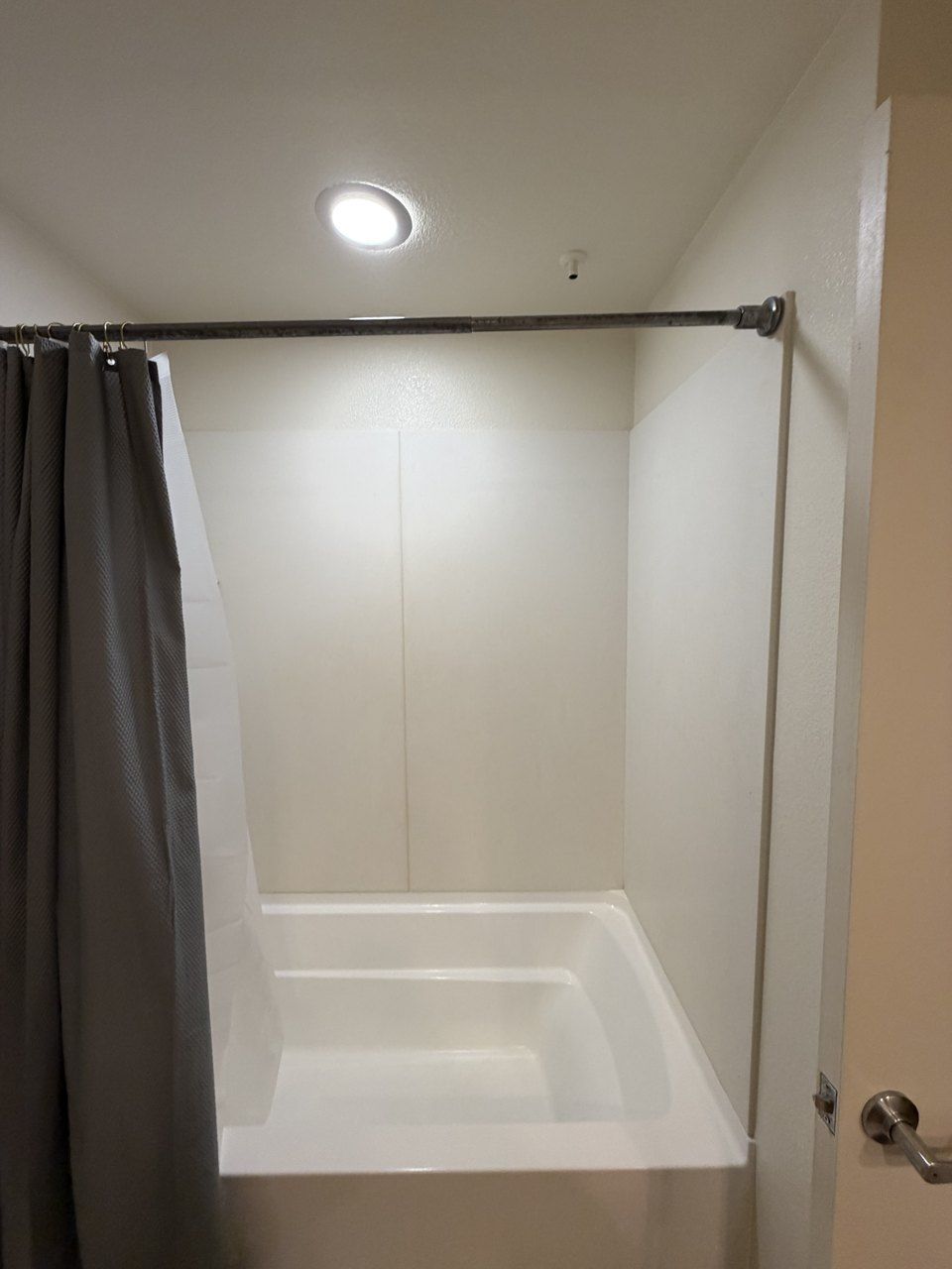 Bathtub in a San Jose apartment with the AC emergency condensate outlet in the ceiling above it