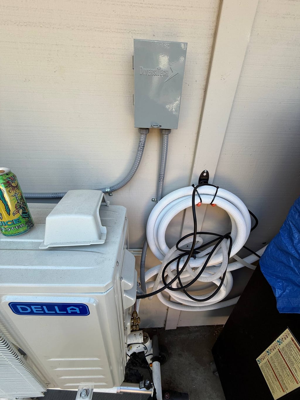 Excess insulated line set coiled beside the outdoor mini-split before repair in Danville