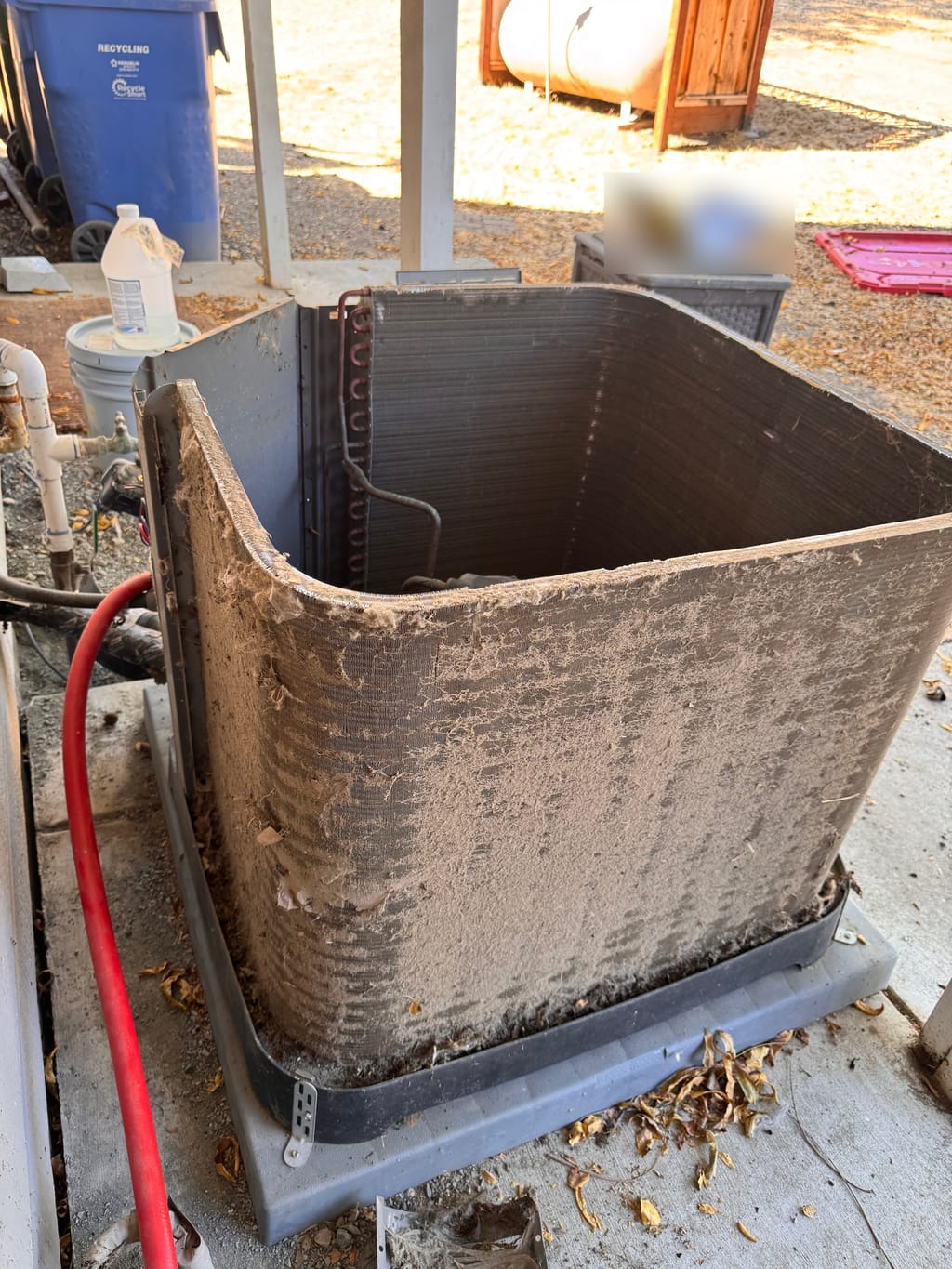 Dust and lint on a Rheem outdoor coil before cleaning in Clayton